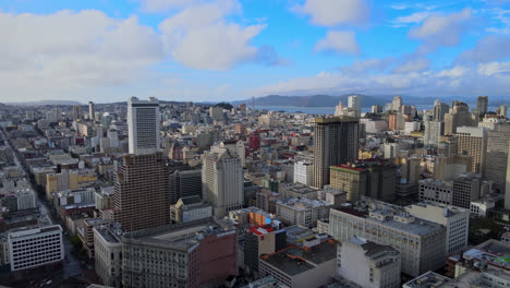 Aerial-of-San-Francisco-Union-Square-neighbourhood-skyline-buildings-with-Golden-Gate-Bridge-in-background,-California,-USA