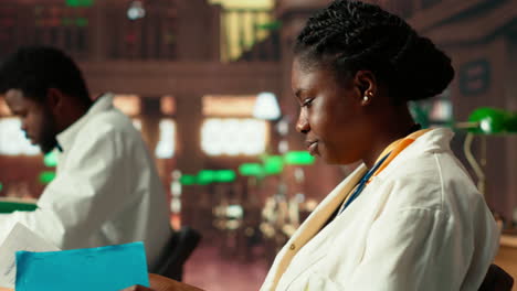 african american female med student reviewing healthcare case files