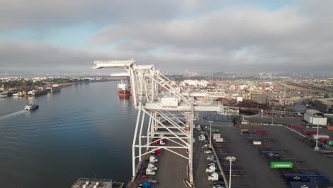 panoramic aerial of cranes, containers and ships at port of oakland, 4k drone shot