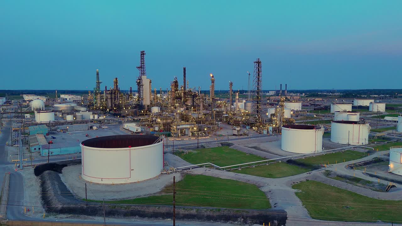 Cenovus Toledo Refinery at dusk with oil tanks and flare stacks in wide view