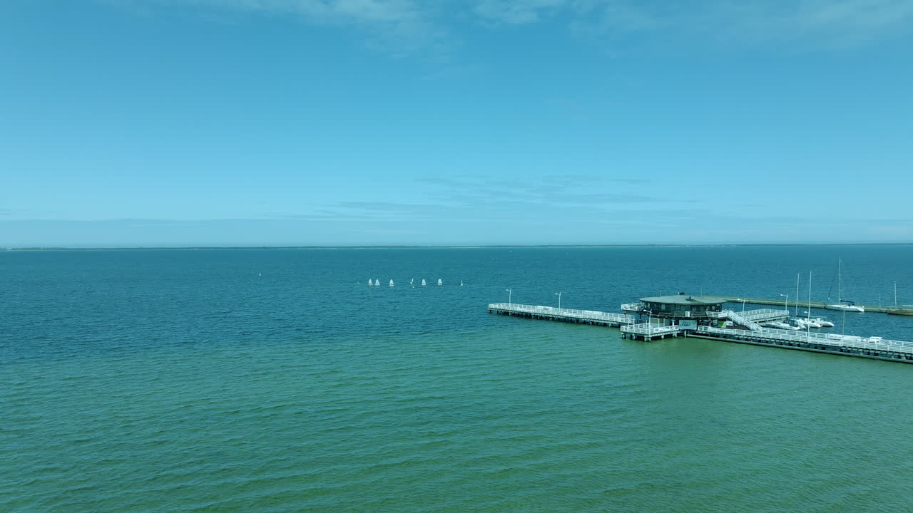 aerial view of the wooden pier over the sea, in the middle of the bridge wooden building, Zatoka Pucka Poland