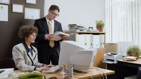 woman using a retro computer in vintage office.