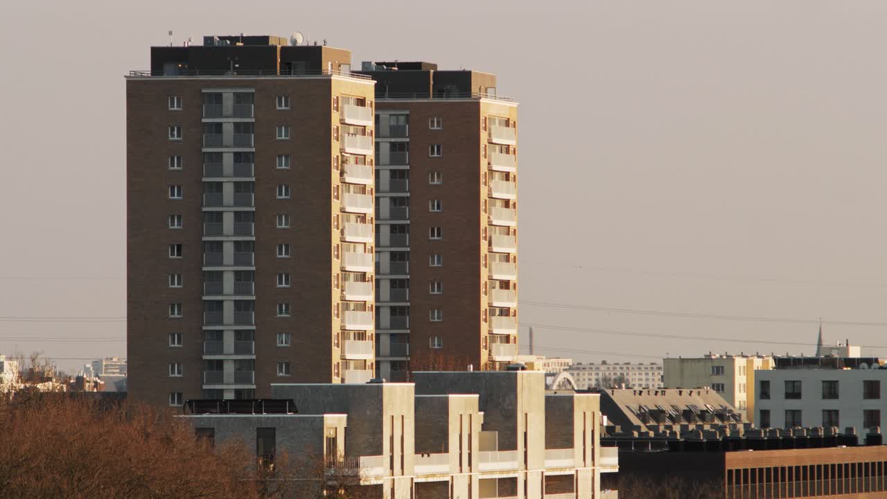 Close-up of two identical high-rise blocks in Luchtbal, Antwerp, in soft sunset light