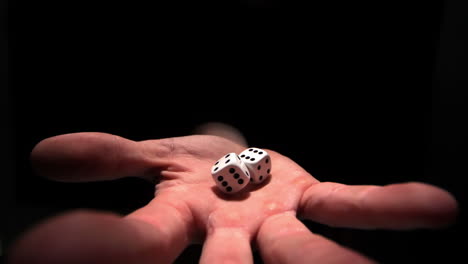 hands grasping white dice