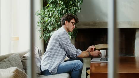 man working on laptop at home