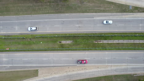 Birds-eye-view-of-an-american-highway,-cars-driving-down-the-freeway