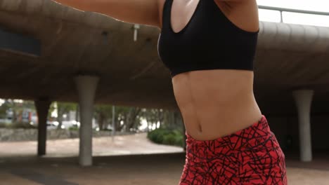 Front-view-of-young-African-American-woman-exercising-in-the-city-4k