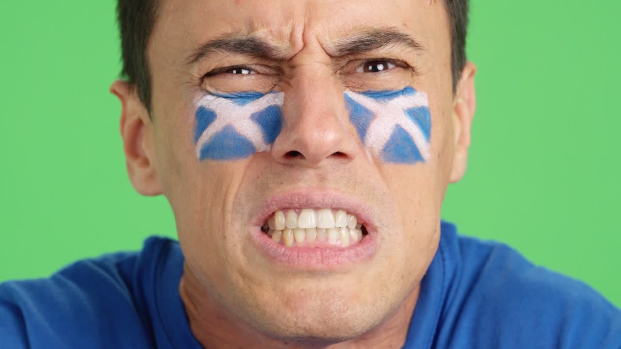Man with scottish national flag upset with a referee