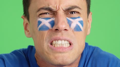 man with scottish national flag upset with a referee
