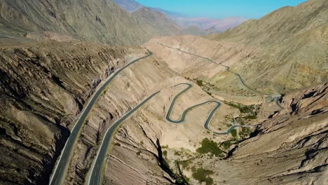 winding road with green fields and mountains of the chuquibamba district taken from the air