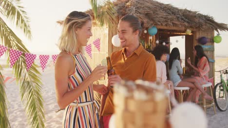 Caucasian-couple-enjoying-a-party-at-beach-