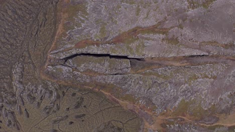 Top-down-aerial-of-famous-crevasse-Lambafell-in-abstract-Iceland-landscape