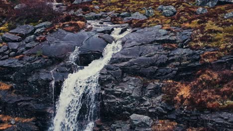 small waterfall in the forest in åfjord, norway - aerial pullback