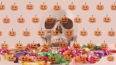 Animation-of-pumpkins-over-skull-and-sweets-on-white-background