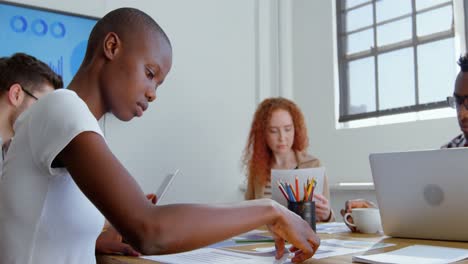 Side-view-of-young-mixed-race-business-team-working-in-meeting-room-of-modern-office-4k