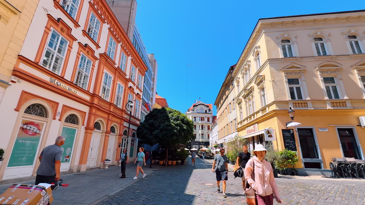 Stroll by the beautiful street with stunning architecture. Low angle view at the historical buildings of Bratislava, Slovakia
