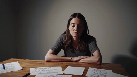 woman sitting at a table deep in thought