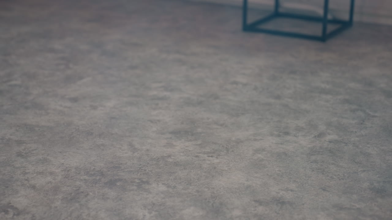 black top hat falling onto dusty studio floor, thick smoke swirling around stool frame, sun light streaming through tall windows, creating ethereal vintage ambiance with textured concrete surface