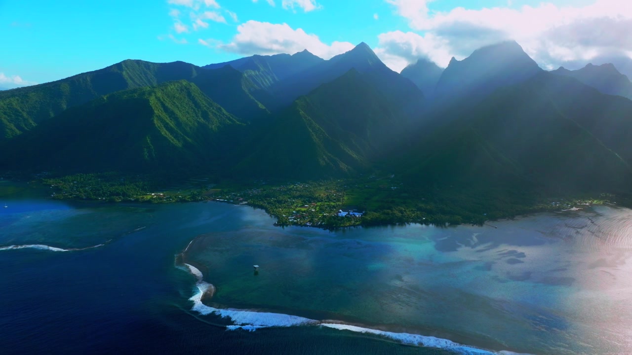 Teahupo'o wave surf spot WSL tour early morning Tahiti lagoon aerial drone harbor view French Polynesia Passe Havea vibrant coral reef South Pacific Ocean island landscape sunny coastline backward pan