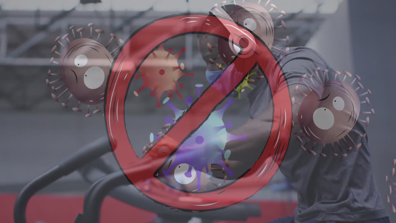 여러 코로나19 세포가 체육관에서 운동하는 얼굴 마스크를 쓰고 있는 남자를 향해 움직이는 것을 멈추십시오.