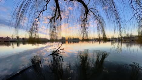 Jib crane shot at the lake with a stunning reflection of the sunset