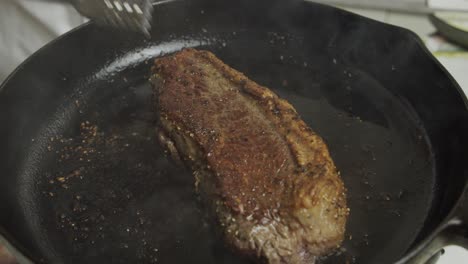 frying meat steak inside frying pan