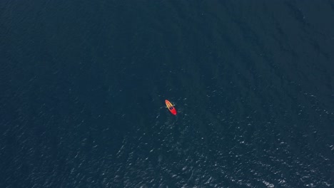 man kayaking in the middle of the ocean in san pablo island philippines aerial shot