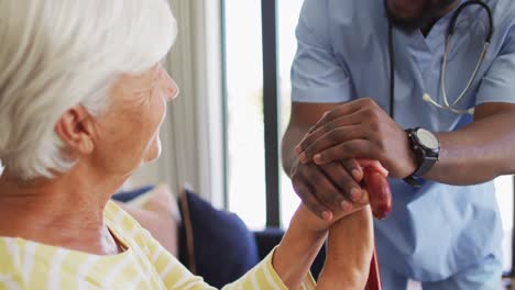 Video-of-happy-african-american-male-doctor-supporting-caucasian-senior-woman