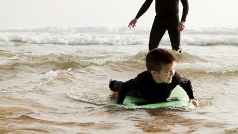 adorable happy boy swimming on board