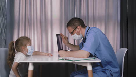 doctor checks temperature and girl throws mask in hospital