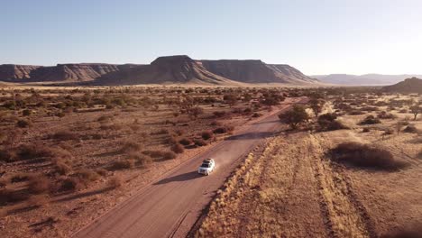 Adventure-Across-Endless-Dunes:-4K-drone-shot-of-Desert-Drive-in-Namibia,-Africa-with-Rooftop-Tented-4x4-Toyota-Hilux