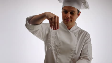 chef sprinkling seasoning