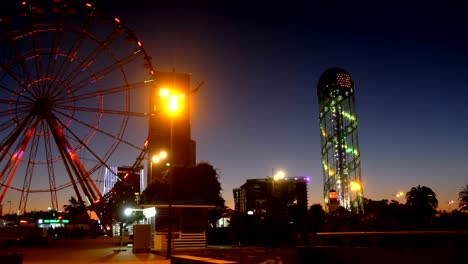 panoramic view statue of ali and nino on a background ferris wheel at night on the embankment of batumi, georgia