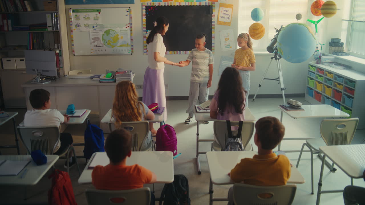 Elementary School Students Talking About Energy Sources in Front of Classmates and Teacher