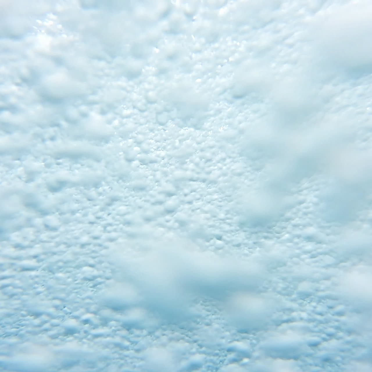 Process of getting off the water slide in summer day. Man goes down from water roller coaster into the swimming pool. Happy time inside the colorful pipe in aqua park.
