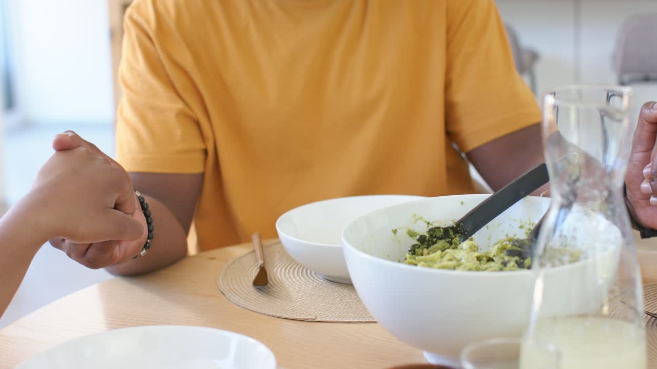 Couple holding hands shifting hands locking showing affection at table with yellow tee