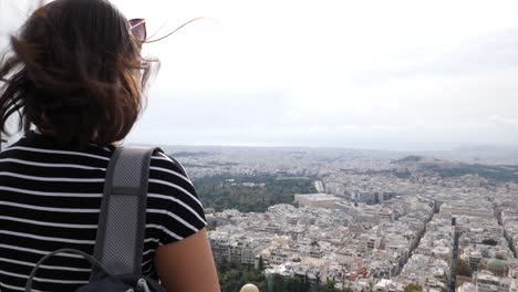 a young asian woman takes a photo with her smartphone and turns around and smiles