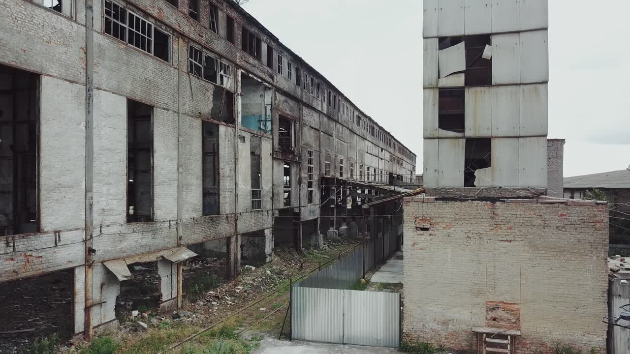 Take-off of the drone at an abandoned factory. Old abandoned factory building. Aerial View