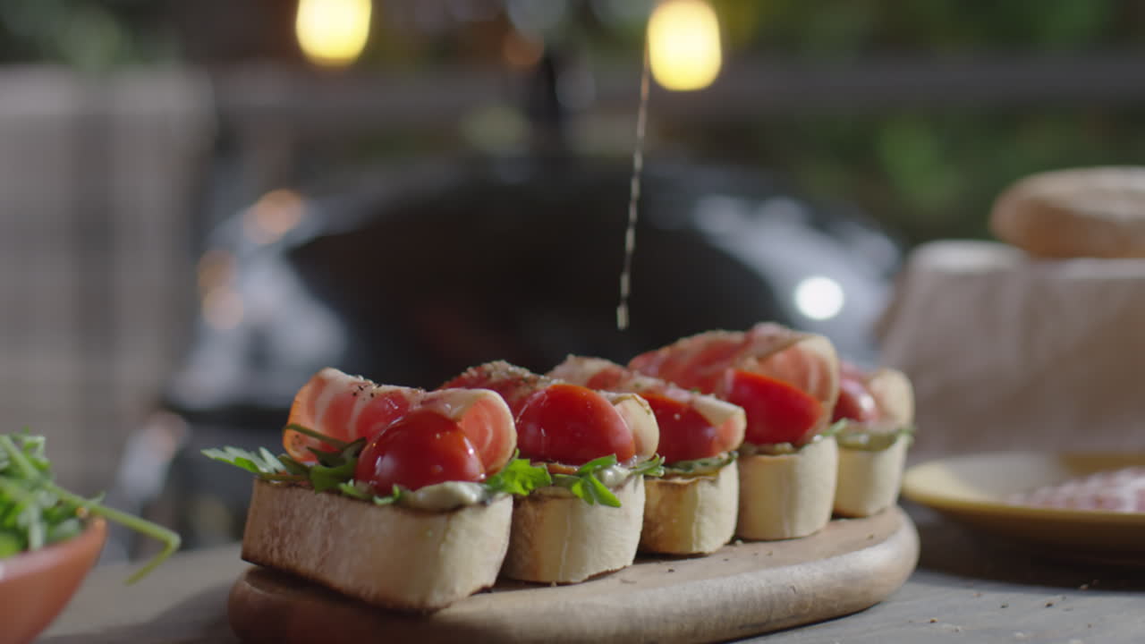 Pouring Olive Oil over Bruschettas