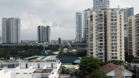 Ho-Chi-Minh-Vietnam-District-2-skyline-and-apartment-buildings,-aerial-rising