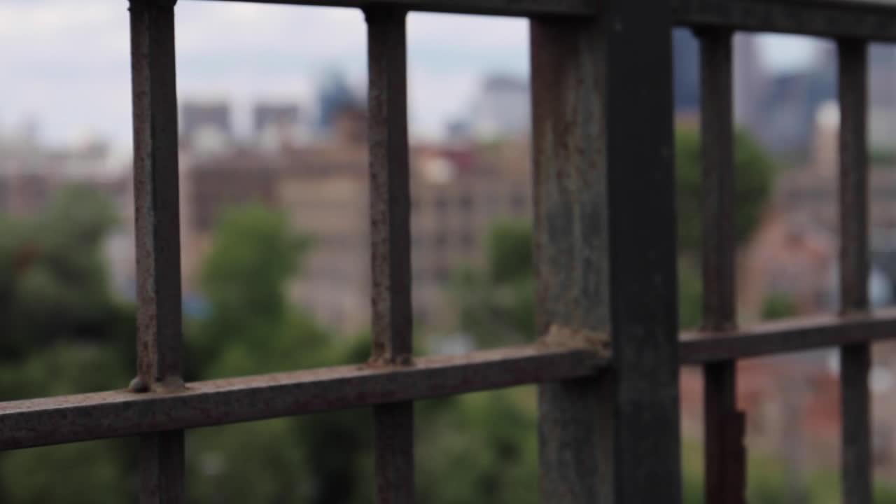 Cityscape through metal bars