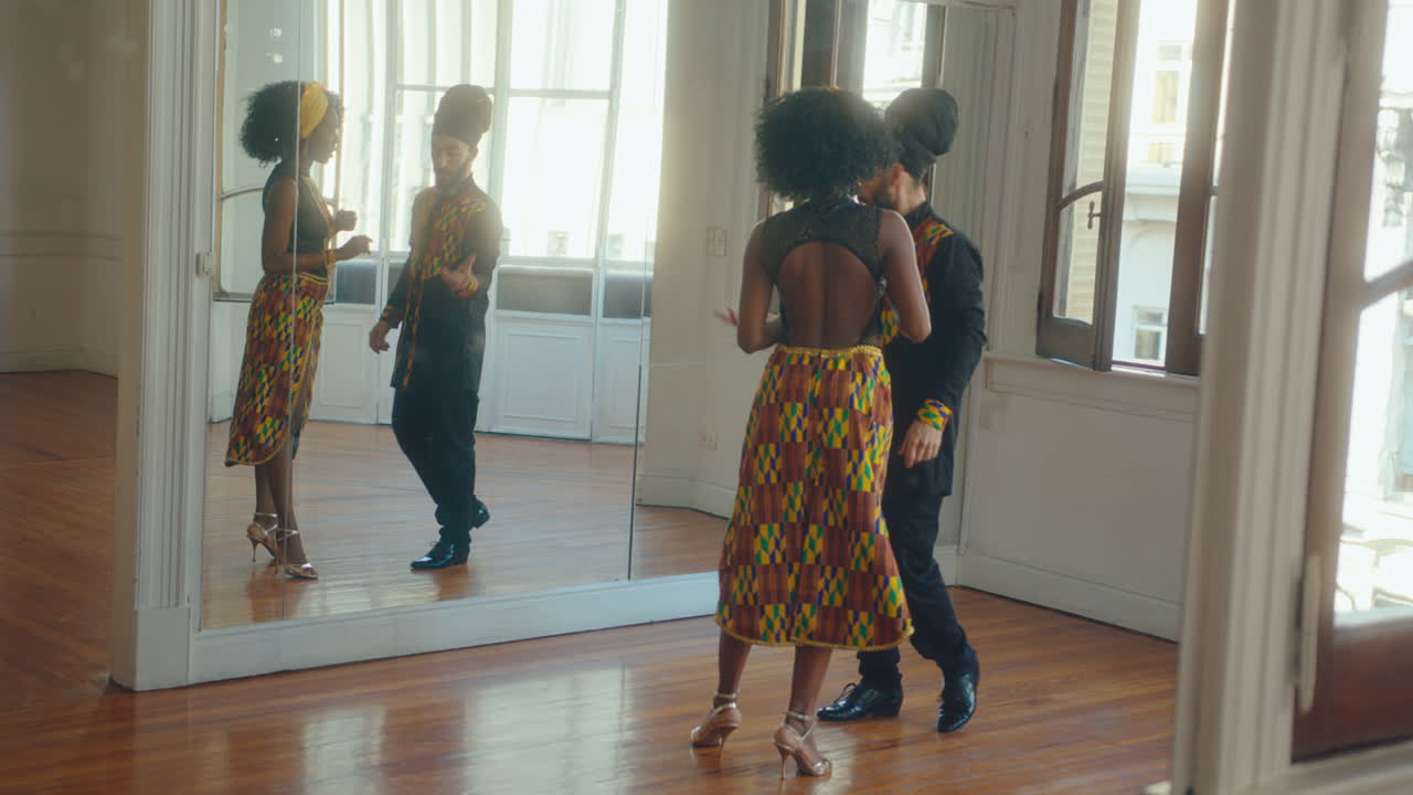 Black Woman Learning Tango with Male Instructor in Dance Studio