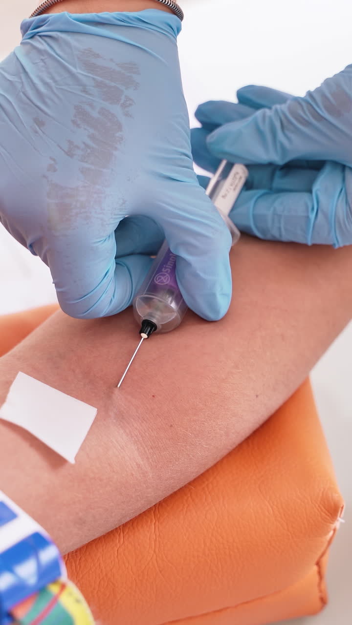 Patient during blood collection. Nurse taking blood sample for test in laboratory. Vertical video