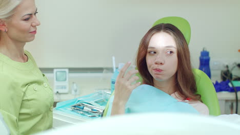 girl gargling mouth after stomatology treatment. woman rinsing mouth