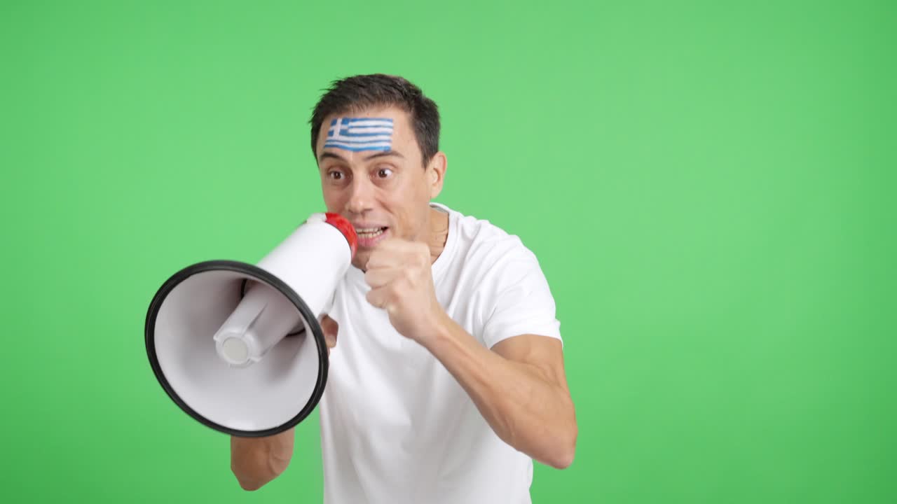 Excited man with greek flag on face using a megaphone