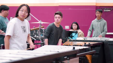 high school students rehearsing music and movement to the show they are to perform.