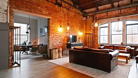 modern industrial living room with leather sofas and brick wall