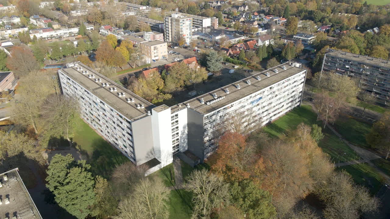 Jib up of social housing flat with green park in autumn