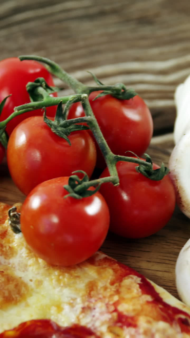 Italian pizza on wooden table with vegetables and spices