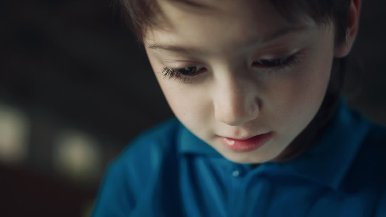 Portrait serious pupil watching tablet screen surfing internet on school break.